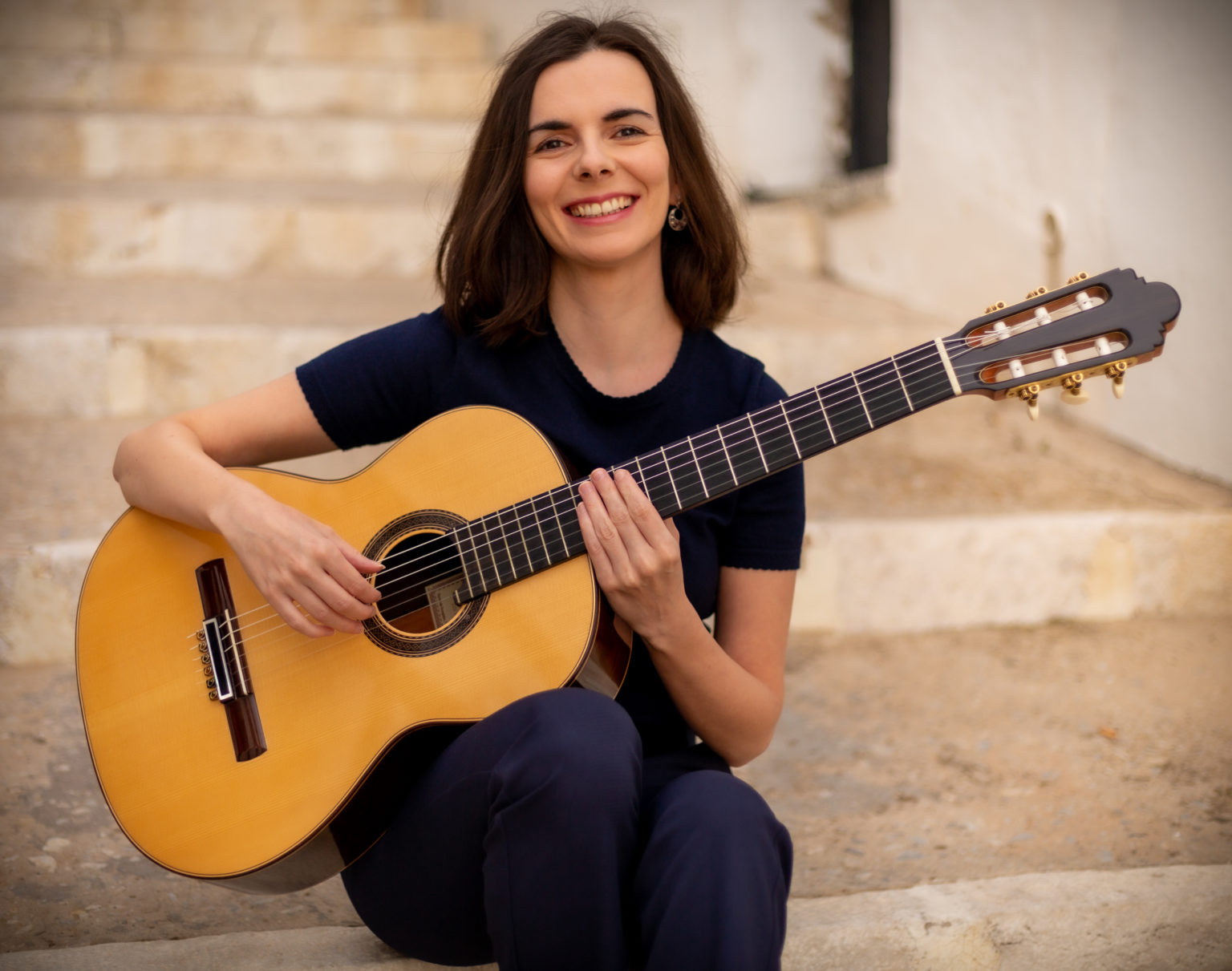 Sanja Plohl with a classical guitar